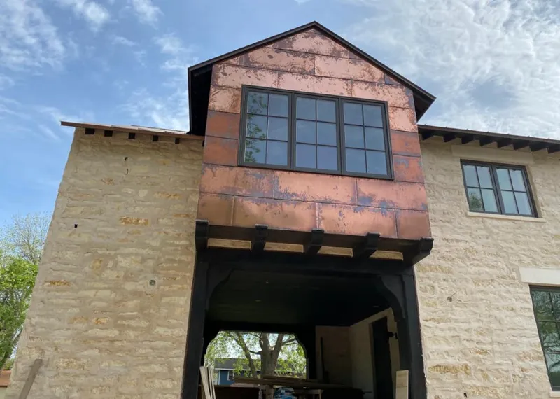 Copper metal panel facade on a stone building for Skylight Installation in Geneseo